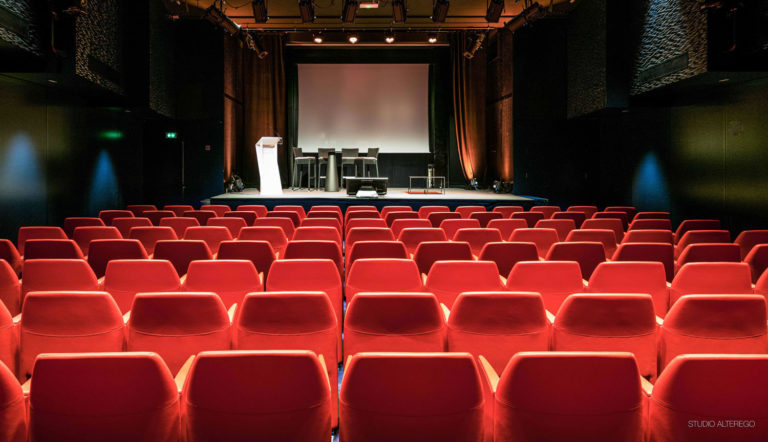 The 150-seat screening room at Le Cercle d’Aumale, red seats facing the screen